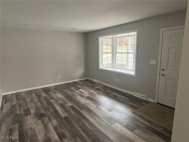 spare room featuring dark hardwood / wood-style floors