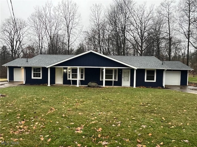 single story home with a garage and a front lawn