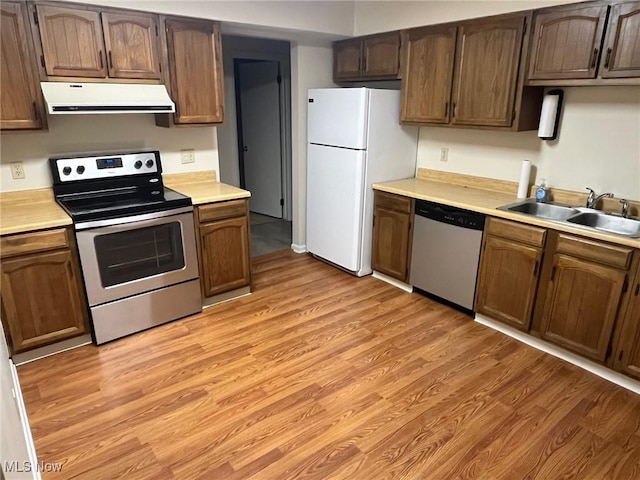 kitchen with sink, light hardwood / wood-style floors, and appliances with stainless steel finishes