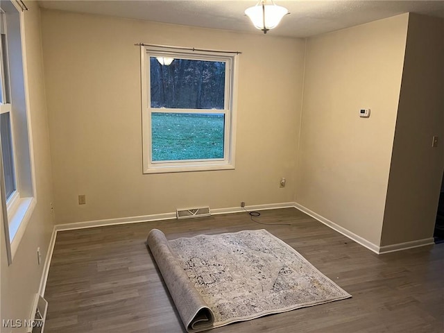 empty room with dark wood-type flooring