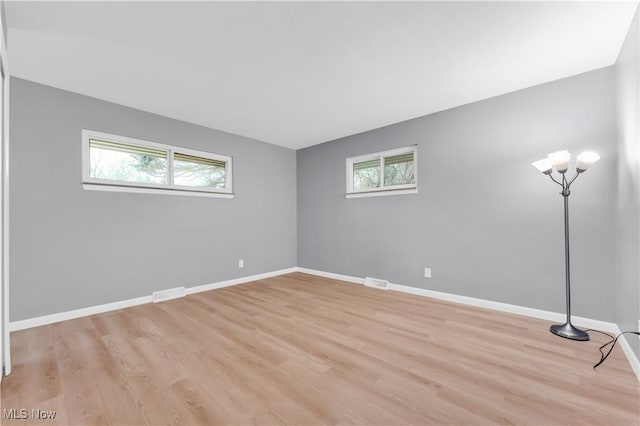 empty room with light hardwood / wood-style floors