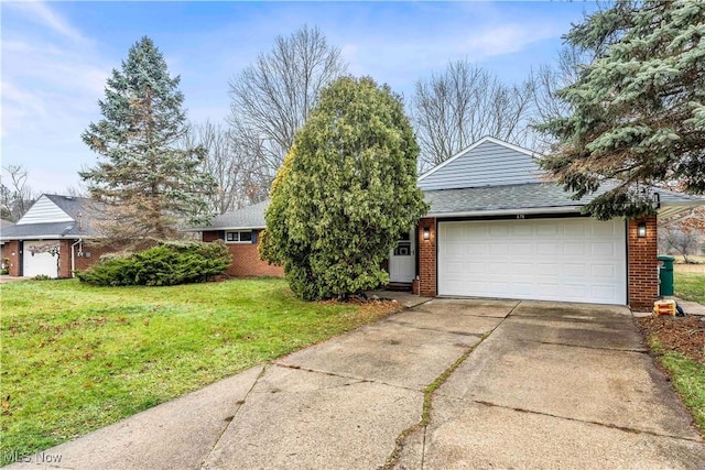 view of front of house featuring a garage and a front lawn