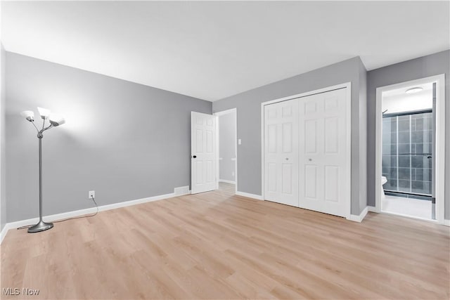 unfurnished bedroom with light hardwood / wood-style floors and a closet