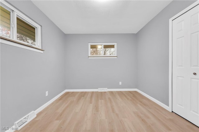 unfurnished room with light hardwood / wood-style flooring