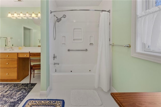 bathroom featuring tile patterned floors, shower / bath combo with shower curtain, and vanity