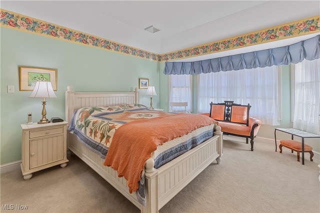 carpeted bedroom featuring multiple windows