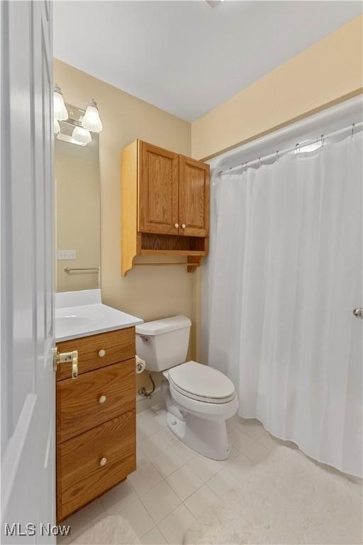 bathroom with tile patterned floors, vanity, and toilet