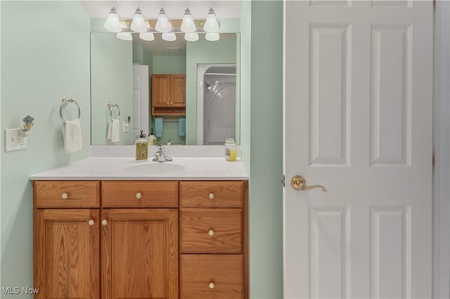 bathroom featuring a shower and vanity