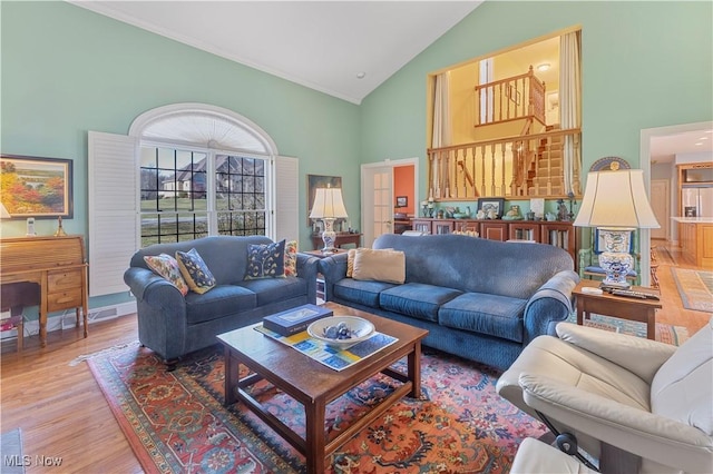 living room featuring hardwood / wood-style floors and high vaulted ceiling