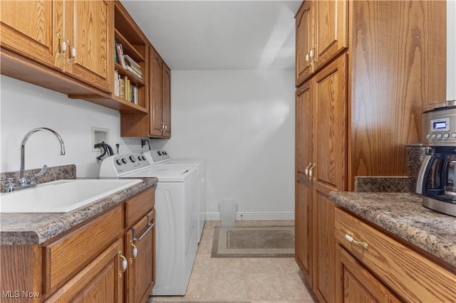 laundry room featuring washer and clothes dryer, sink, and light tile patterned floors