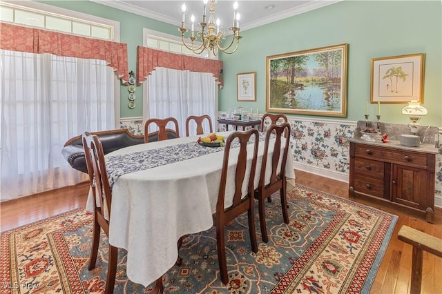 dining area with a wealth of natural light, dark hardwood / wood-style flooring, a chandelier, and ornamental molding