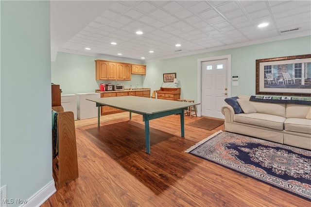 rec room featuring light hardwood / wood-style floors and crown molding