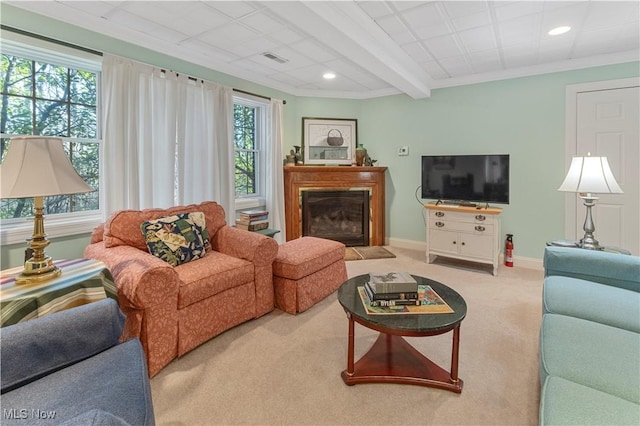 living room with beam ceiling, light colored carpet, and ornamental molding