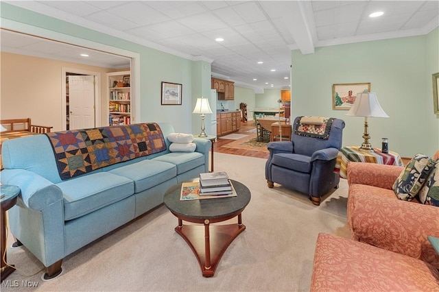 carpeted living room featuring ornamental molding