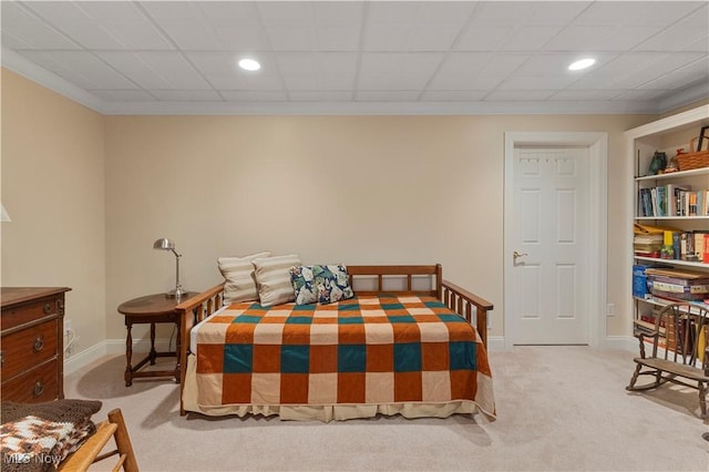 bedroom with light colored carpet and crown molding