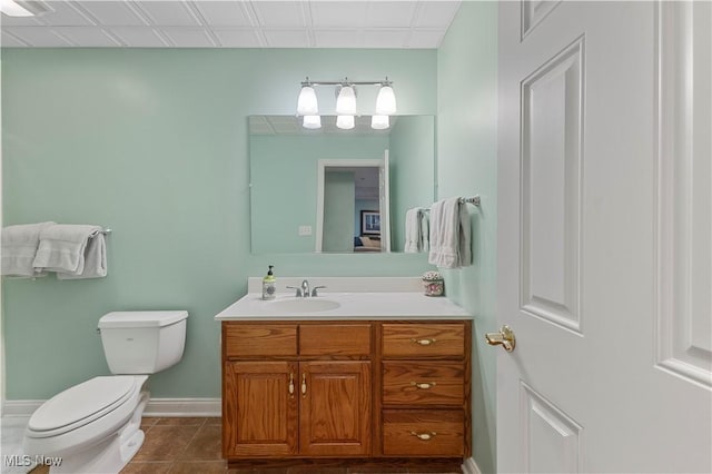 bathroom featuring toilet, vanity, and tile patterned floors