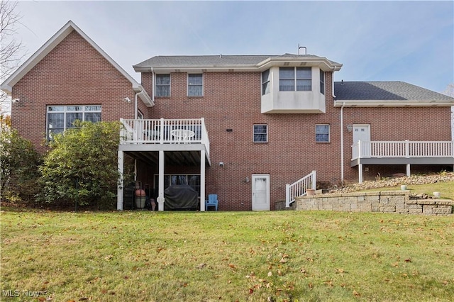 back of house with a lawn and a deck