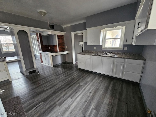 kitchen with sink, white cabinets, and a healthy amount of sunlight