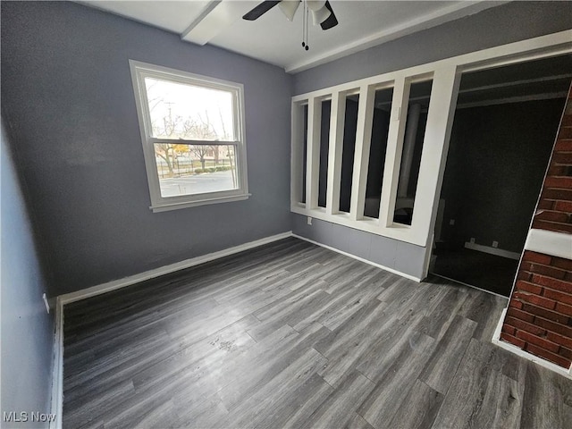 unfurnished bedroom with ceiling fan and dark hardwood / wood-style floors