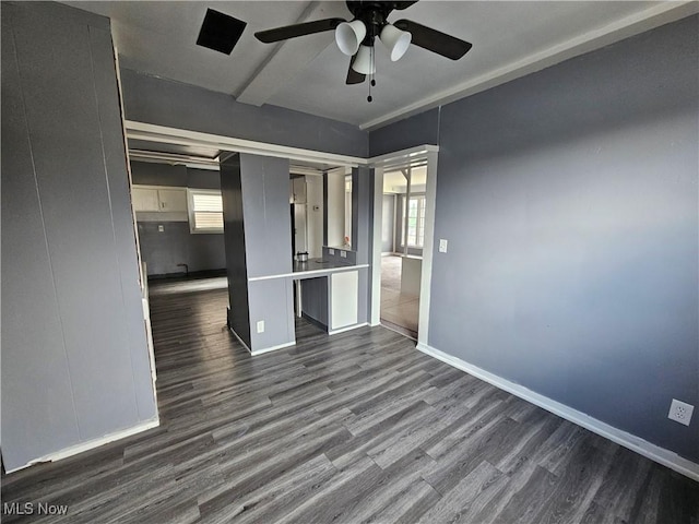 unfurnished room featuring ceiling fan, beamed ceiling, and dark hardwood / wood-style floors