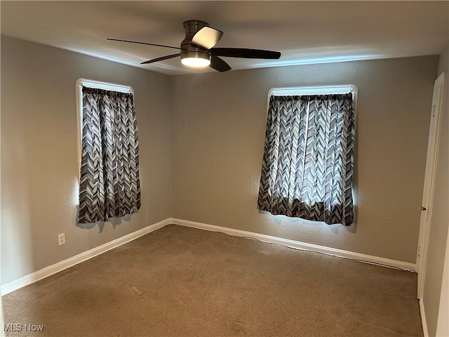 spare room with carpet and ceiling fan