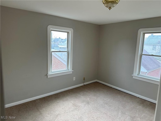 unfurnished room featuring carpet