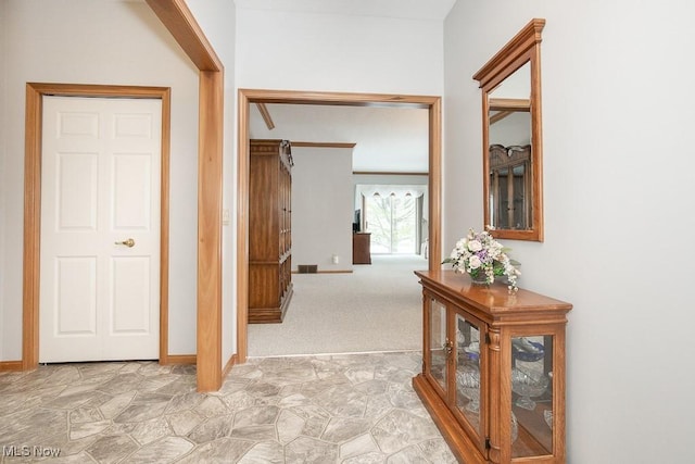 corridor with light colored carpet