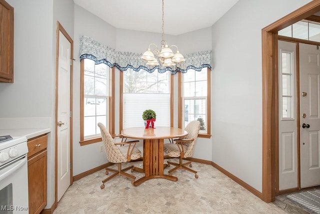 dining area with a healthy amount of sunlight and an inviting chandelier