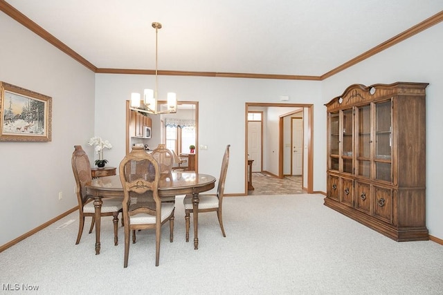 dining area featuring ornamental molding, light colored carpet, and a notable chandelier