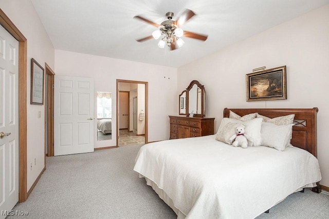 carpeted bedroom with ceiling fan and a closet