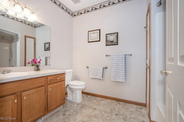 bathroom featuring a shower, vanity, and toilet