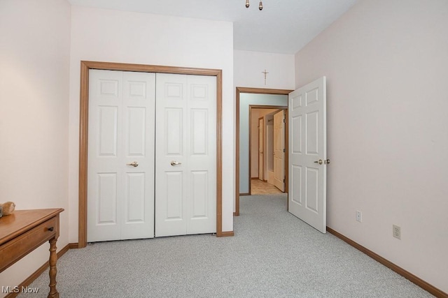 bedroom with light carpet and a closet