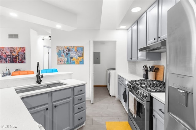 kitchen featuring sink, electric panel, gray cabinets, washer and dryer, and appliances with stainless steel finishes