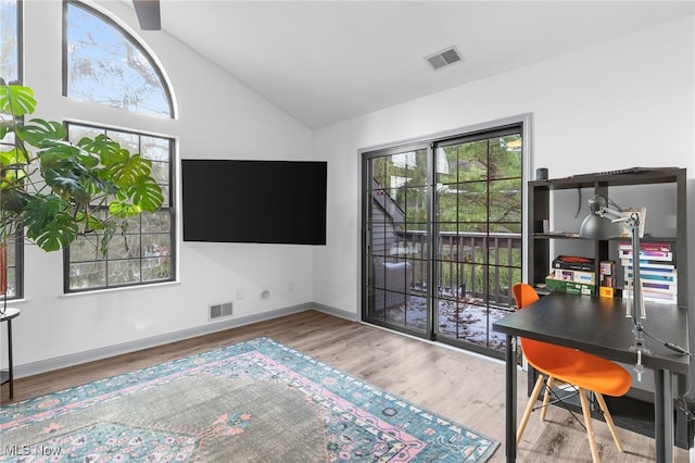 office with plenty of natural light, lofted ceiling, and light hardwood / wood-style flooring