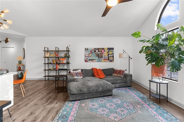 living room featuring ceiling fan, hardwood / wood-style floors, and vaulted ceiling