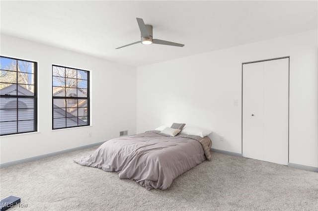 bedroom featuring ceiling fan, carpet floors, and a closet