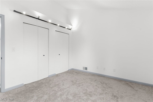 unfurnished bedroom with light carpet