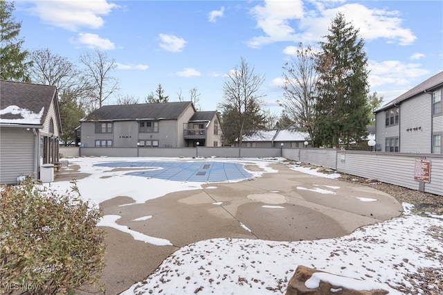 snow covered pool with a patio