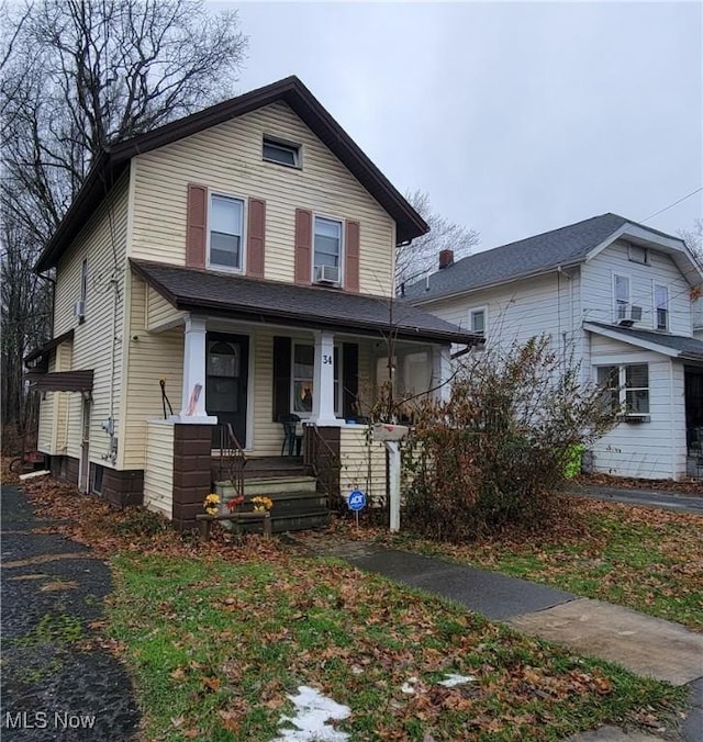 view of front of property featuring a porch and cooling unit