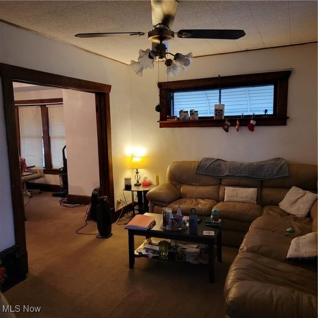 carpeted living room with ceiling fan