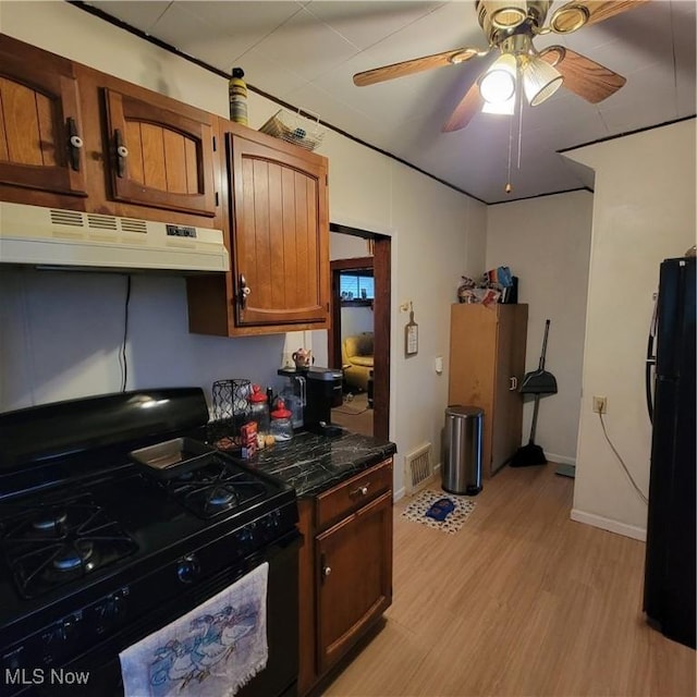 kitchen with ceiling fan, black appliances, and light wood-type flooring