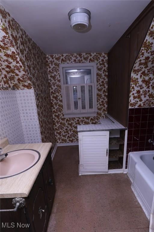 bathroom with a bath and vanity