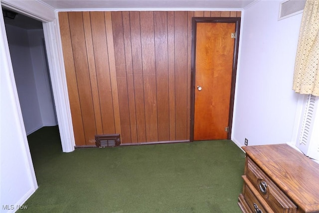 interior space featuring dark carpet and crown molding