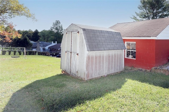 view of outbuilding featuring a lawn