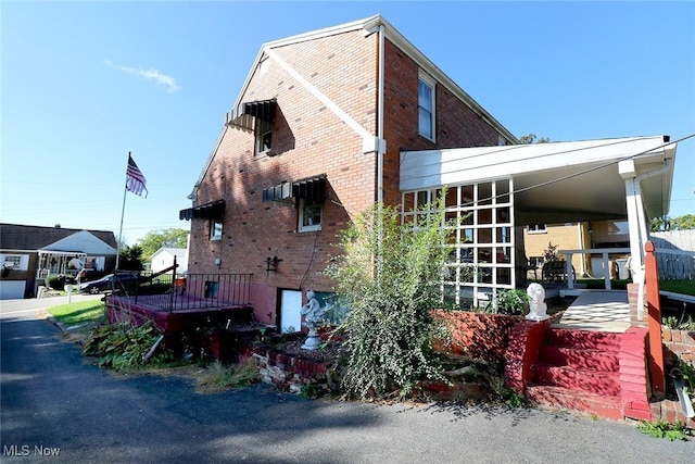 view of home's exterior with a carport