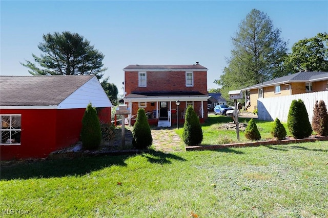 rear view of property featuring a yard