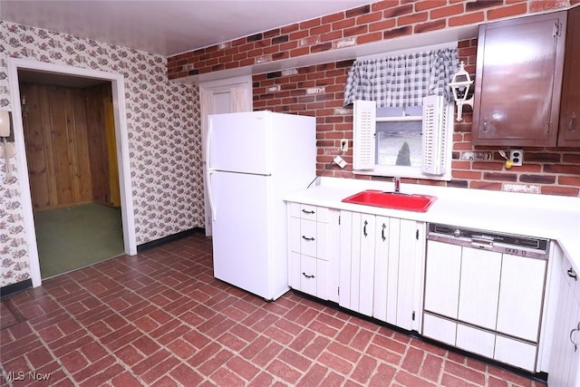 kitchen featuring white cabinetry, sink, and white appliances