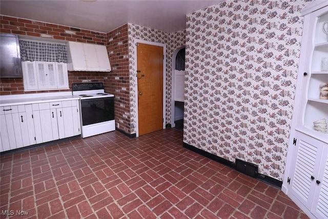 kitchen with white cabinetry and white electric stove