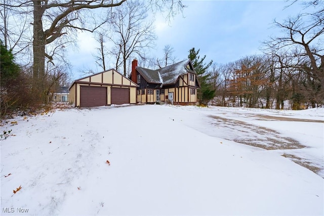 exterior space with an outbuilding and a garage