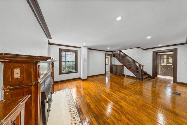 unfurnished living room with crown molding and wood-type flooring